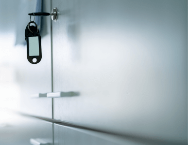 Ein Schlüssel steckt in einem verschlossenen Aktenschrank mit metallischer Oberfläche. Die Szene symbolisiert Vertraulichkeit und Schutz sensibler Daten – etwa im Kontext des Bankgeheimnisses.