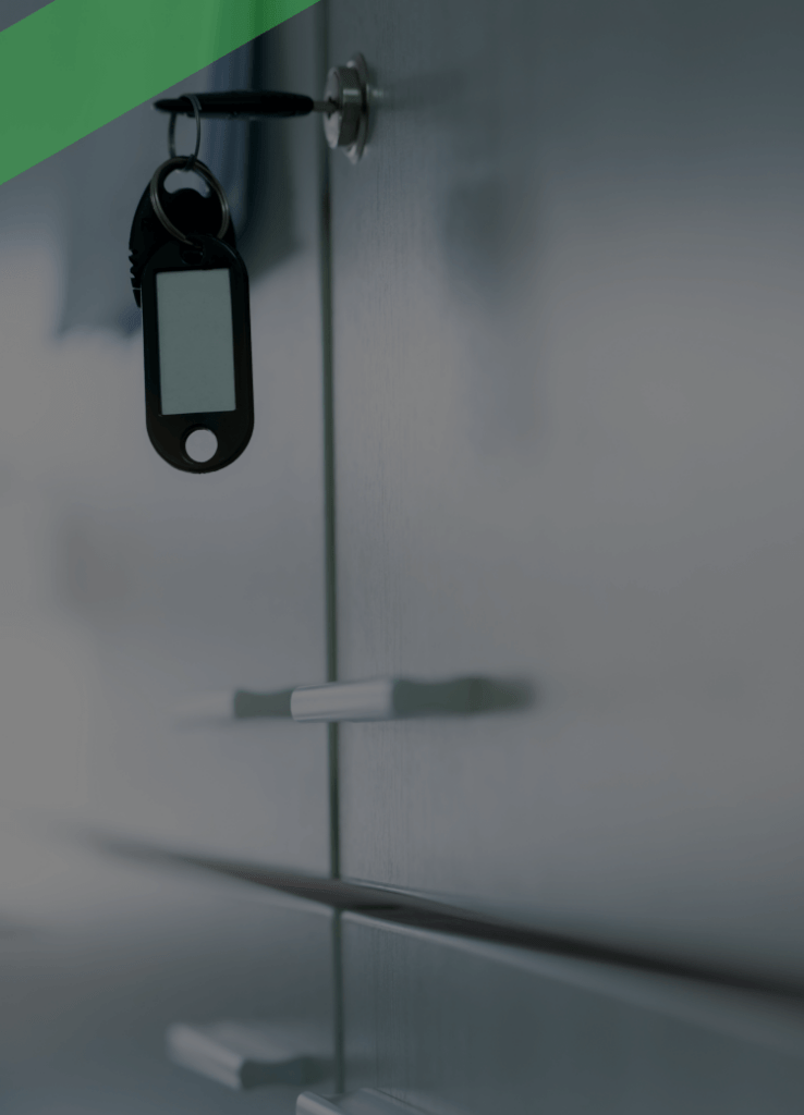 Ein Schlüssel steckt in einem verschlossenen Aktenschrank mit metallischer Oberfläche. Die Szene symbolisiert Vertraulichkeit und Schutz sensibler Daten – etwa im Kontext des Bankgeheimnisses.