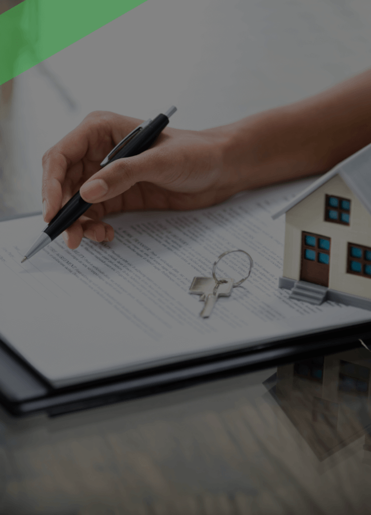 Eine Person unterschreibt einen Vertrag auf einem Klemmbrett, daneben liegen ein Schlüsselbund und ein kleines Modellhaus. Die Szene symbolisiert eine Immobilien- oder Kreditrefinanzierung, bei der bestehende Kreditkonditionen durch neue ersetzt werden.